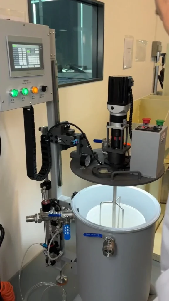 Industrial glue production line machinery in operation, showing automated filling process for adhesive manufacturing.