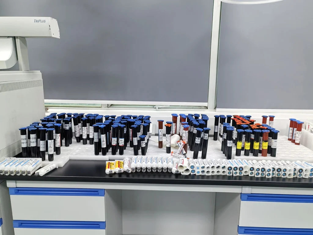 Various finished UV adhesive sample tubes placed on laboratory workbench for formula testing and inspection