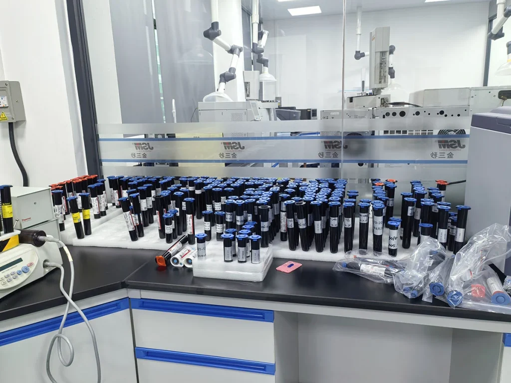 Various finished UV adhesive sample tubes placed on laboratory workbench for formula testing and inspection