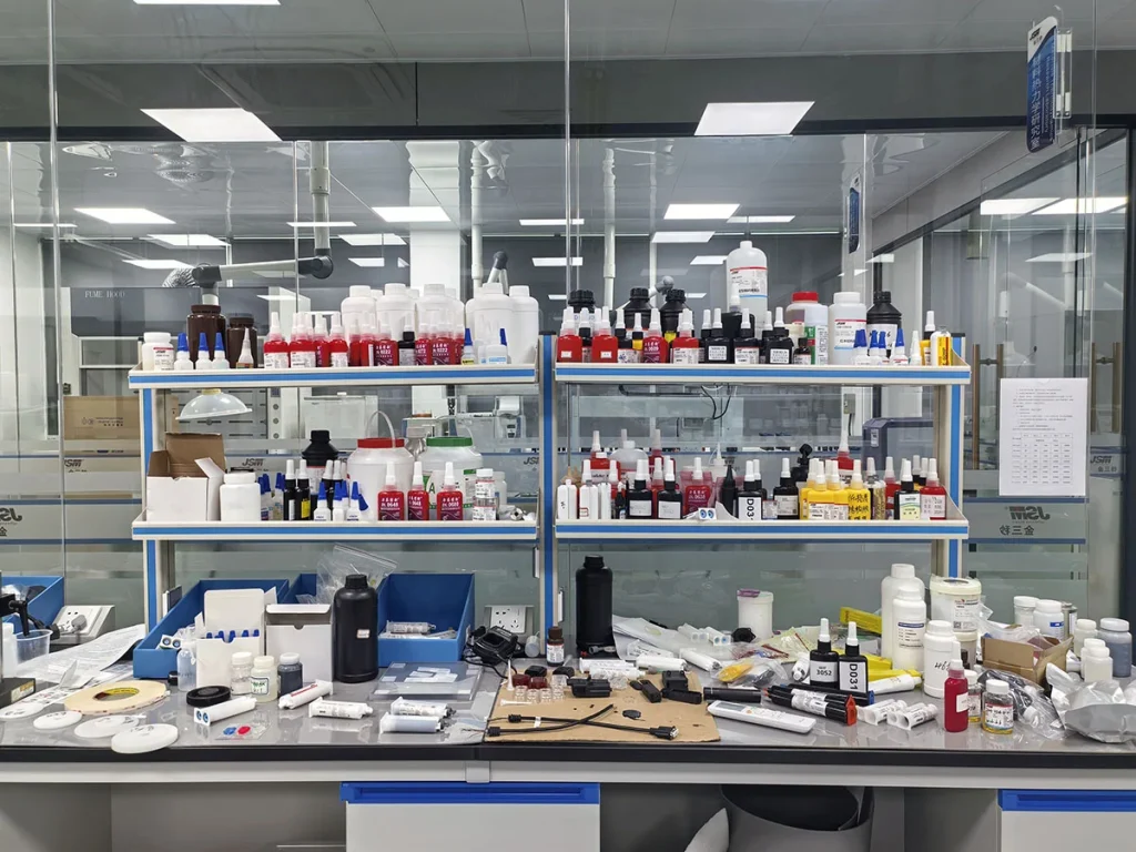 Industrial UV adhesive laboratory, technicians testing industrial glue bonding performance
