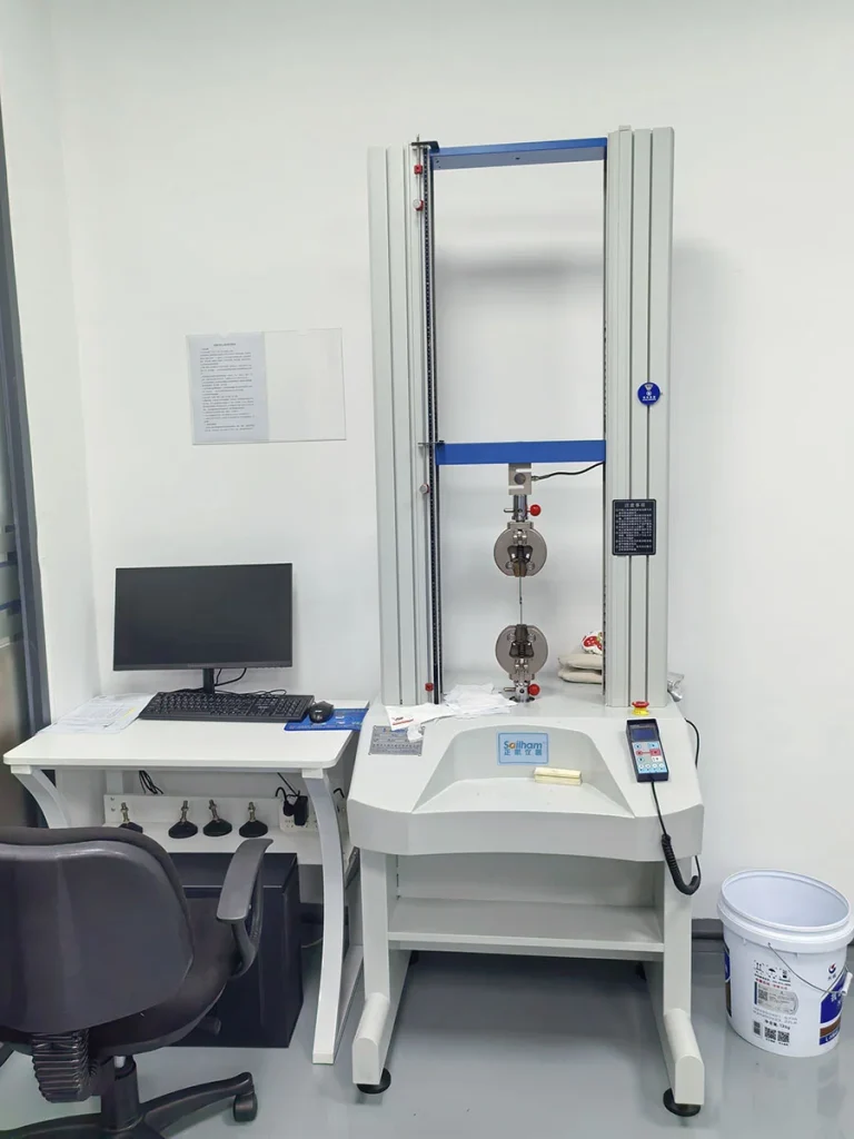 Universal tensile testing machine in adhesive laboratory, testing bonding tensile strength of industrial UV glue