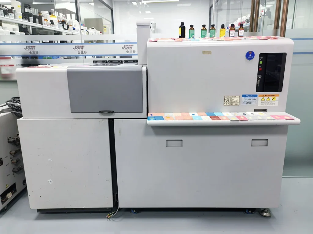 UV adhesive curing performance testing machine with color sample cards in clean R&D laboratory for industrial glue solidification test