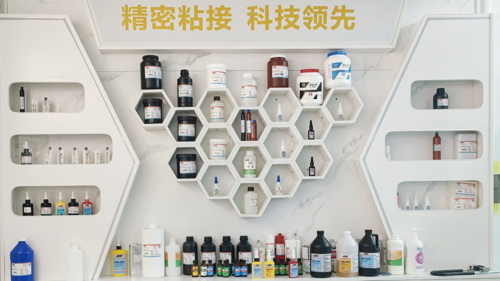Showroom display wall with full range of industrial UV adhesive samples, various glue bottles and test tubes for precision bonding solutions